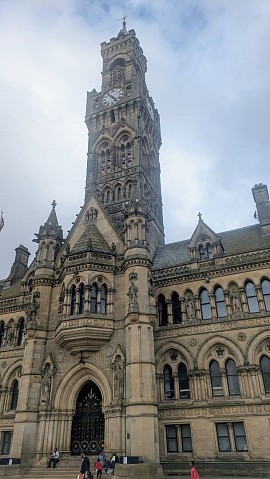 The historic Victorian clock tower and façade of Bradford City Hall.